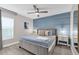 Comfortable bedroom featuring a queen bed with a blue accent wall at 4431 Le Reve Ct, Kissimmee, FL 34746