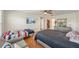 Bedroom featuring wood floors, a ceiling fan, a flat-screen television, and 2 beds at 5239 Los Palma Vista Dr, Orlando, FL 32837