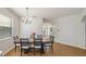 Dining room featuring hardwood flooring, chandelier, and a decorative table setting ready for a meal at 5239 Los Palma Vista Dr, Orlando, FL 32837