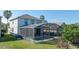 Exterior view of the house with a screened-in pool and well maintained lawn at 5239 Los Palma Vista Dr, Orlando, FL 32837