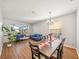 Bright living room with hardwood floors, natural light, blue sofas, and decorative table at 5239 Los Palma Vista Dr, Orlando, FL 32837