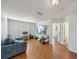 Cozy living room with hardwood floors, white walls, and a large flat-screen television at 5239 Los Palma Vista Dr, Orlando, FL 32837