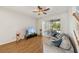 Relaxing living room with a sliding door to patio and ceiling fan, featuring wood-look flooring at 5239 Los Palma Vista Dr, Orlando, FL 32837