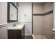 Bathroom with modern vanity, tiled shower featuring a sleek accent stripe, and tiled floors at 524 W Winter Park St, Orlando, FL 32804