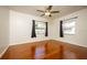 Cozy bedroom with hardwood floors, neutral walls, and two windows for natural light at 524 W Winter Park St, Orlando, FL 32804