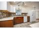 Well-lit kitchen features white and brown cabinets, sleek countertops, and stainless appliances at 524 W Winter Park St, Orlando, FL 32804