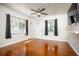 Bright living room with hardwood floors, two windows, and an elegant ceiling fan at 524 W Winter Park St, Orlando, FL 32804