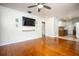 Open-concept living room leading to a well-equipped kitchen with hardwood floors and modern fixtures at 524 W Winter Park St, Orlando, FL 32804