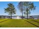 Expansive backyard featuring manicured lawn, mature trees, and water views at 535 Spring Club Dr, Altamonte Springs, FL 32714