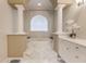 Bright bathroom features a luxurious, tiled tub with decorative columns and white cabinets at 535 Spring Club Dr, Altamonte Springs, FL 32714