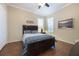 Cozy bedroom with hardwood floors, a comfortable bed, and natural light offers a serene retreat at 535 Spring Club Dr, Altamonte Springs, FL 32714