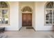 Inviting front entrance features arched windows and an impressive solid wood double door at 535 Spring Club Dr, Altamonte Springs, FL 32714