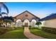 Attractive home with a paver walkway, well manicured landscaping and arched entryways at 535 Spring Club Dr, Altamonte Springs, FL 32714