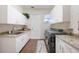 Functional laundry room with ample cabinet space, granite counters, and a modern washer/dryer at 535 Spring Club Dr, Altamonte Springs, FL 32714