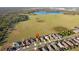 Aerial photograph of houses with a red location pin on one of the houses with a large field and lake at 5571 Sycamore Canyon Dr, Kissimmee, FL 34758