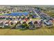 An aerial shot of houses near a lake with a red location pin on one of the houses in the neighborhood at 5571 Sycamore Canyon Dr, Kissimmee, FL 34758