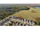 Overhead shot of houses with a red location pin on one of the houses with a large field and lake at 5571 Sycamore Canyon Dr, Kissimmee, FL 34758