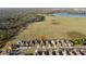 Beautiful aerial photograph of houses with a red location pin on one of the houses with a large field and lake at 5571 Sycamore Canyon Dr, Kissimmee, FL 34758