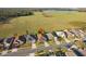 Aerial photograph of houses with a red location pin on one of the houses with a large field and lake at 5571 Sycamore Canyon Dr, Kissimmee, FL 34758