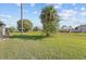 A large, well-maintained backyard boasts mature trees at 56 Pine Island Cir, Kissimmee, FL 34743