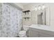 Bathroom with decorative shower curtain, floating shelves and a modern vanity at 56 Pine Island Cir, Kissimmee, FL 34743