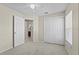 Bedroom with ceiling fan and large closet with adjoining bathroom at 56 Pine Island Cir, Kissimmee, FL 34743