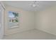 Bright bedroom with ceiling fan and natural light streaming through the window at 56 Pine Island Cir, Kissimmee, FL 34743