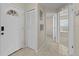 Inviting entryway with neutral tile flooring and coat closet at 56 Pine Island Cir, Kissimmee, FL 34743