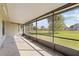 A covered screened patio offers outdoor living space with a view of the green backyard at 56 Pine Island Cir, Kissimmee, FL 34743