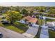 Aerial view of a well-maintained home with a bright roof, landscaping, and a long driveway at 6023 Sage Dr, Orlando, FL 32807