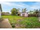 Well-sized backyard with a shed, mature trees, and a lawn at 6023 Sage Dr, Orlando, FL 32807