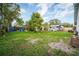 Backyard with large shade tree, shed, and fenced perimeter at 6023 Sage Dr, Orlando, FL 32807