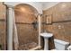 Bathroom featuring custom shower with pedestal sink and tile flooring at 6023 Sage Dr, Orlando, FL 32807