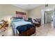 Bedroom featuring tile floors, ceiling fan and a view into the hallway at 6023 Sage Dr, Orlando, FL 32807