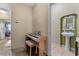 Hallway featuring piano and view of the half bathroom at 6023 Sage Dr, Orlando, FL 32807