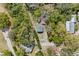 Birds eye view, showing the house nestled amongst the trees, near other homes and rural roads at 655 W Date St, Lake Wales, FL 33859