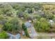 Aerial perspective of the property, highlighting its setting among mature trees and neighborhood at 655 W Date St, Lake Wales, FL 33859