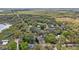 A beautiful aerial view of several quaint homes surrounded by mature trees and expansive green spaces at 655 W Date St, Lake Wales, FL 33859