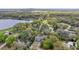 Aerial shot of a blue house, with lake and trees in the background, offering a picturesque view at 655 W Date St, Lake Wales, FL 33859