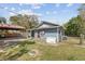 Backyard featuring a covered patio, a Generac generator, and a partially fenced yard at 655 W Date St, Lake Wales, FL 33859