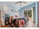 Bedroom with wood floors, a ceiling fan, and sliding glass doors to the backyard at 655 W Date St, Lake Wales, FL 33859