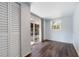 Bedroom with wood floors, a window, a closet, and sliding glass doors to the backyard at 655 W Date St, Lake Wales, FL 33859