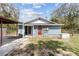 Charming home exterior with a covered porch, well-maintained lawn, and generator at 655 W Date St, Lake Wales, FL 33859