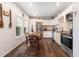 Cozy eat-in kitchen featuring white cabinets, stainless steel appliances, and hardwood floors at 655 W Date St, Lake Wales, FL 33859