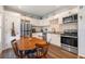 Cozy eat-in kitchen featuring white cabinets, stainless steel appliances, and hardwood floors at 655 W Date St, Lake Wales, FL 33859