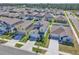 An aerial view of a community with similar homes and manicured lawns at 659 Daring Dr, Davenport, FL 33837