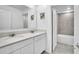 Pristine bathroom with double sinks, modern fixtures, and a tiled shower and bathtub at 659 Daring Dr, Davenport, FL 33837