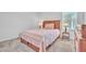 Bedroom with a large bed, wood frame, and a nightstand at 659 Daring Dr, Davenport, FL 33837