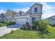 Stylish two-story home with lush landscaping, modern architectural details, and a welcoming blue door at 659 Daring Dr, Davenport, FL 33837