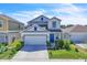 Charming two-story home featuring a well-maintained front yard with a blue front door at 659 Daring Dr, Davenport, FL 33837